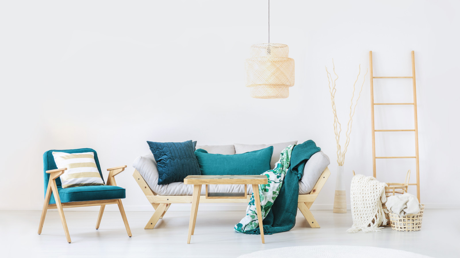Una habitación blanca con una silla de madera, una silla verde y una lámpara iluminando el espacio para inmueble de venta y tasación gratuita